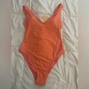 Brand New with tags size medium in coral. Very flattering.